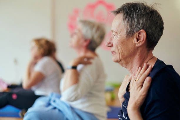 Physiotherapist providing gentle at-home care to a senior patient in Rishikesh