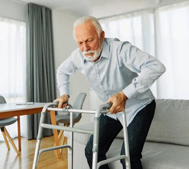 Gentle physiotherapy session with an elderly parent in a home setting